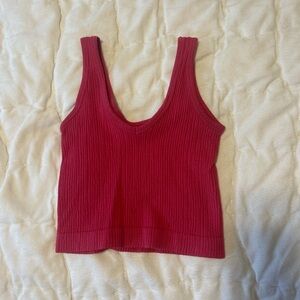 Out from under pink tank top